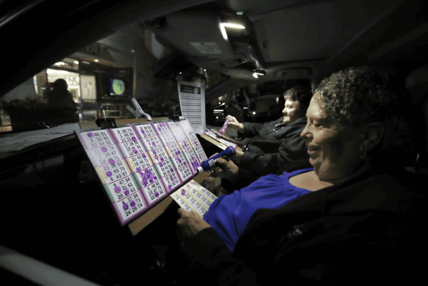 image of person playing bingo in their car